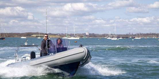 	An image of a couple sailing on a high speed boat