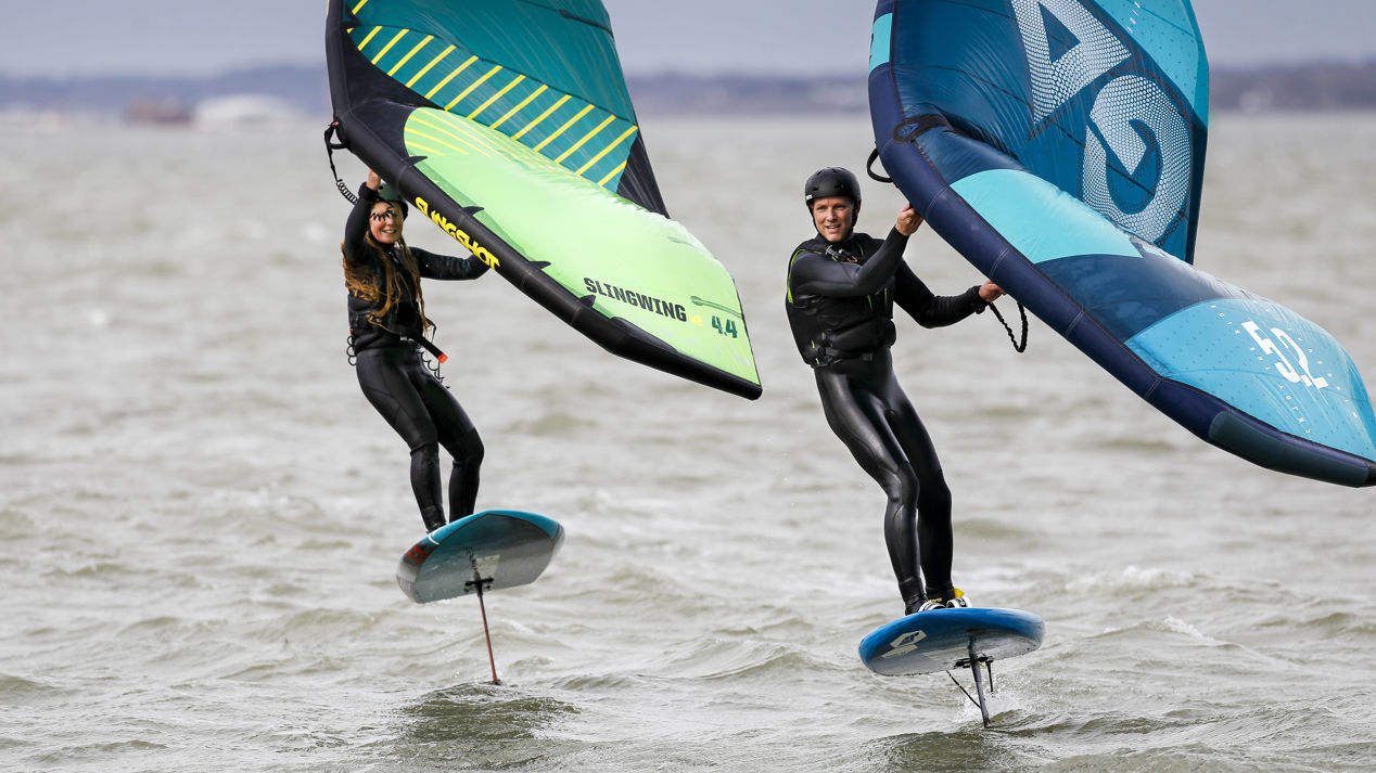 Two windsurfers side by side