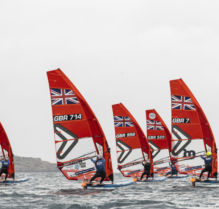 wide shot of British sailing team windsurfers racing each other -  iQFOiL.