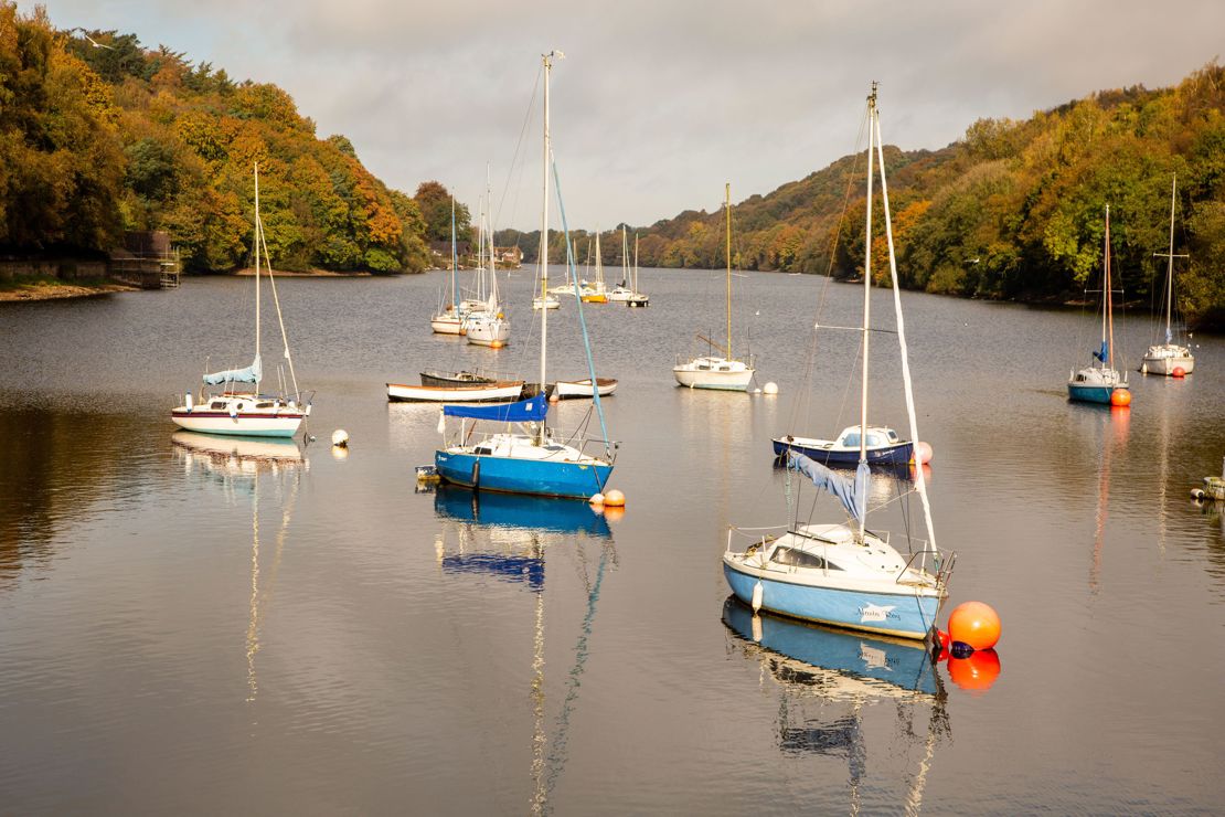 wide shot of sailing boats moored on a river