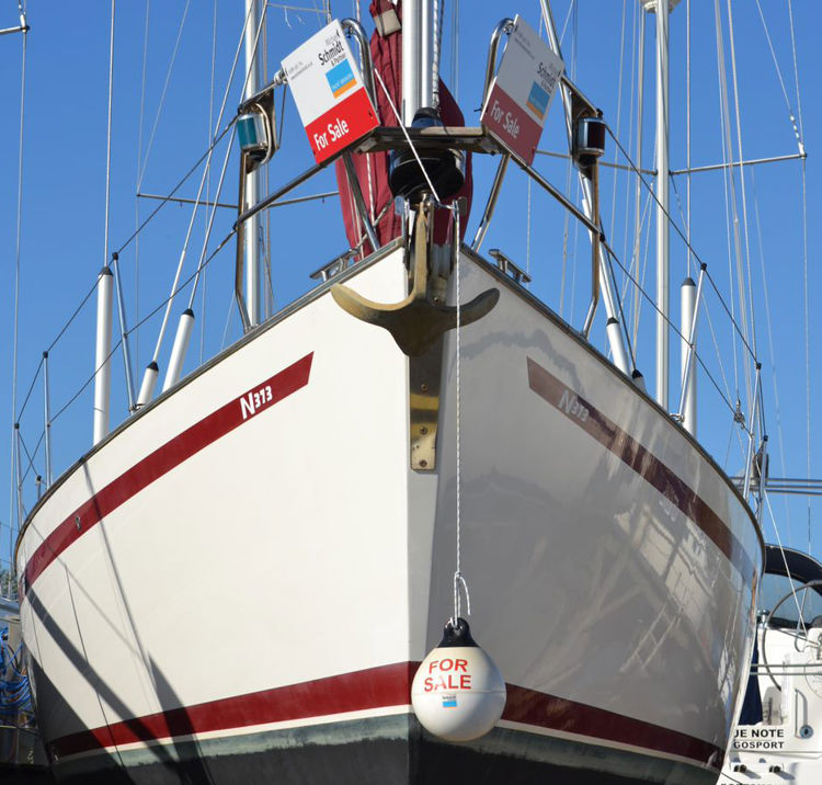 a large yatch with a for sale sign on the stern