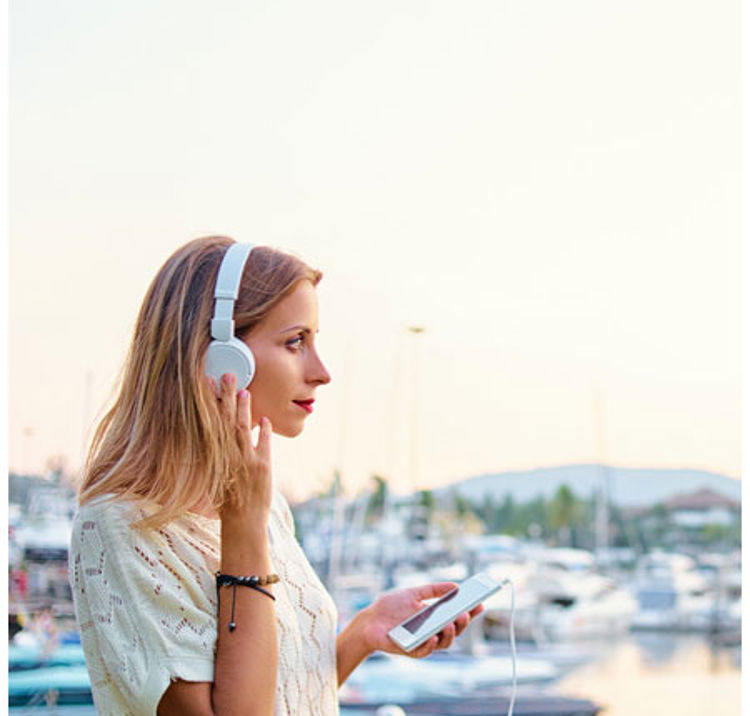 Woman wearing headphones listening to an audiobook