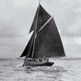 Black and white image of a traditional wooden sail boat