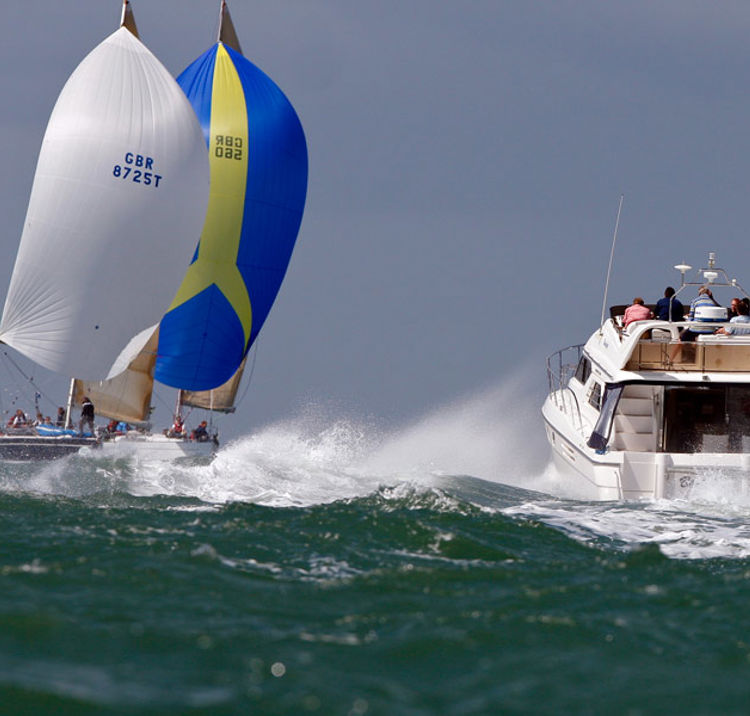 choppy ocean with motor cruiser and sailing yacht in the distance