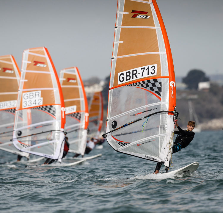 Children board racing in familiar waters