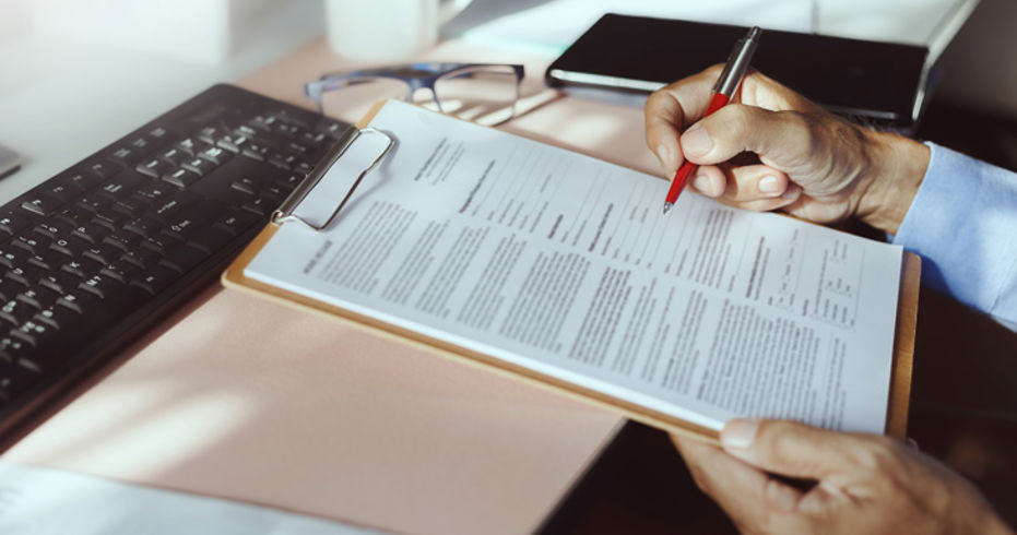 signing of a document on a clipboard