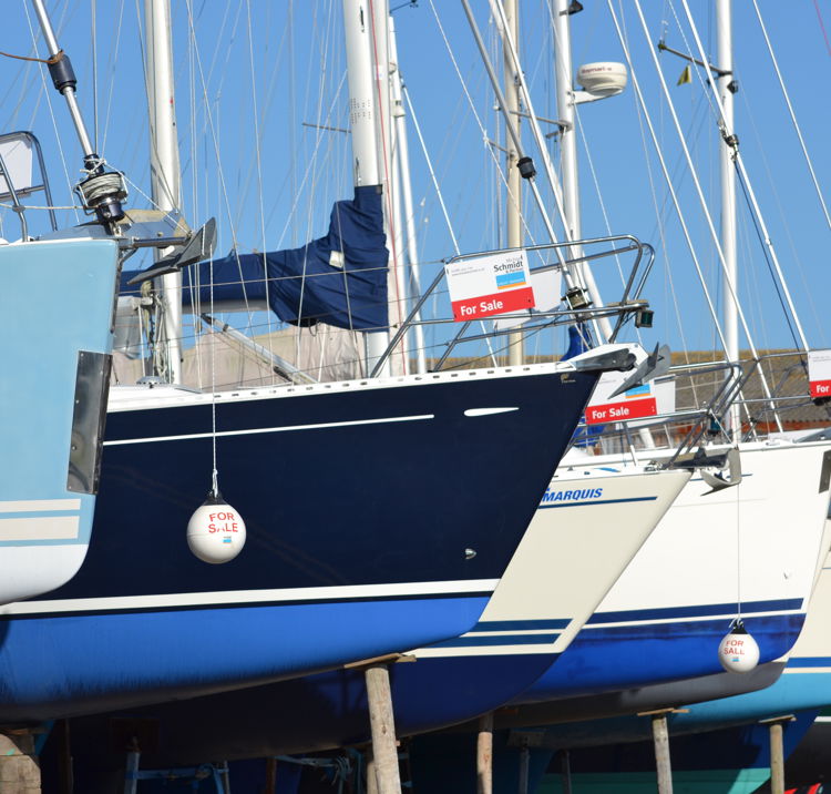 Lots of yachts for sale all in a line on the shore
