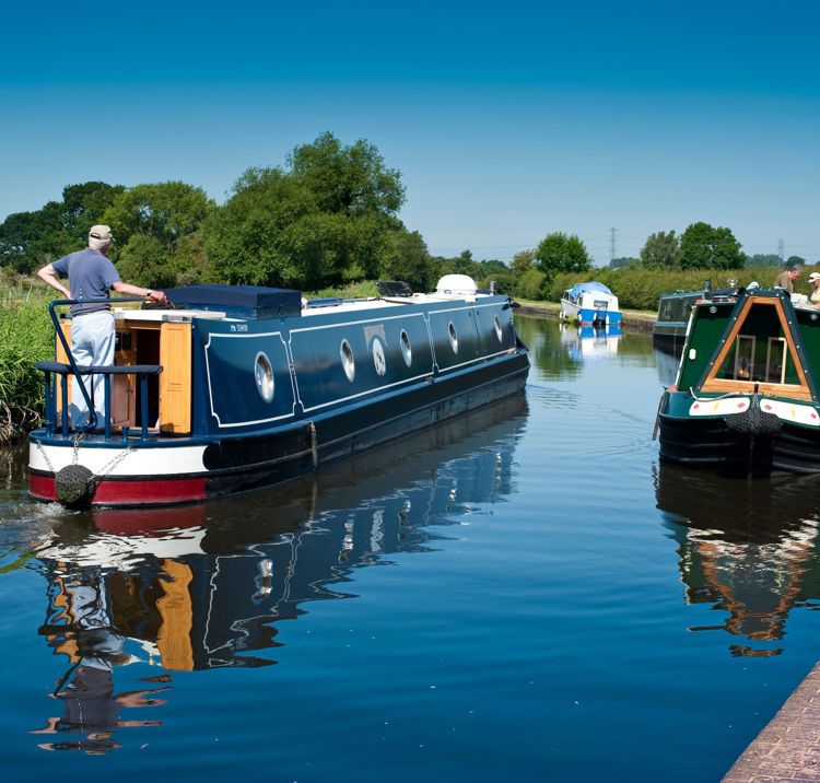 Canal boats sailing along a river