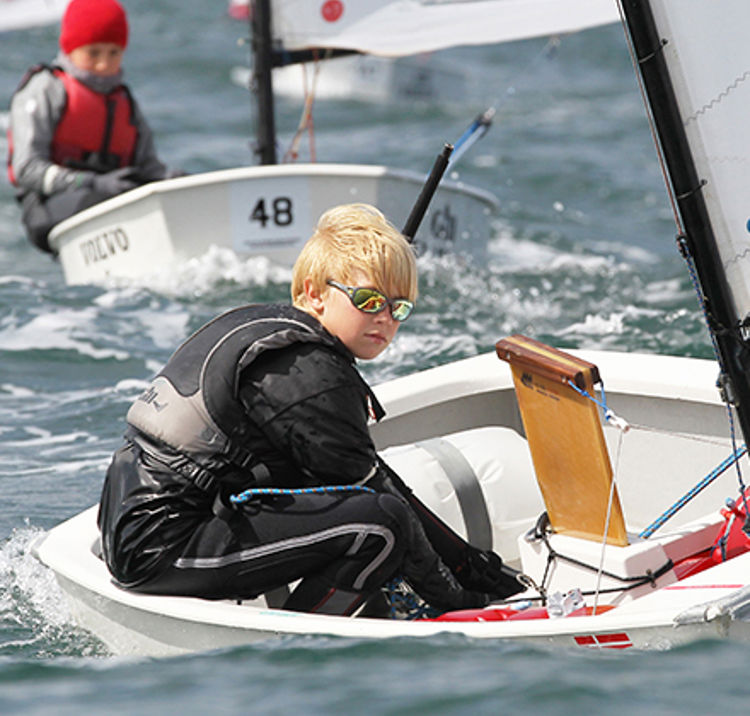 young sailor in a single handed dinghy