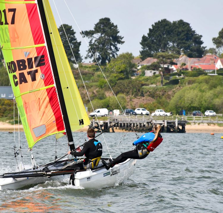 mid shot of sailors using a multihull on sunny day