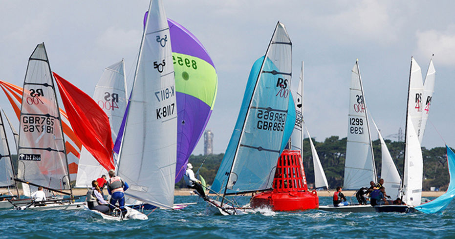colourful dinghies navigating bright blue waters