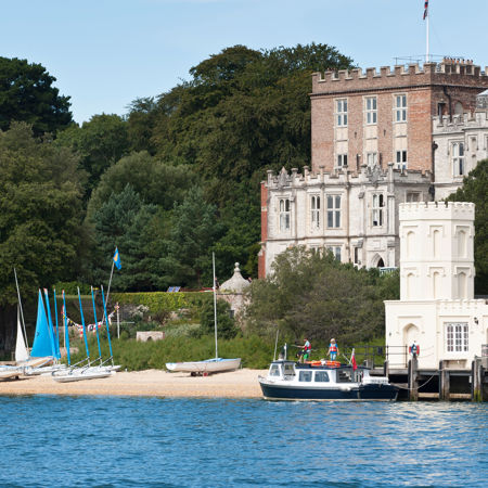 Boats moored along a scenic coastal home