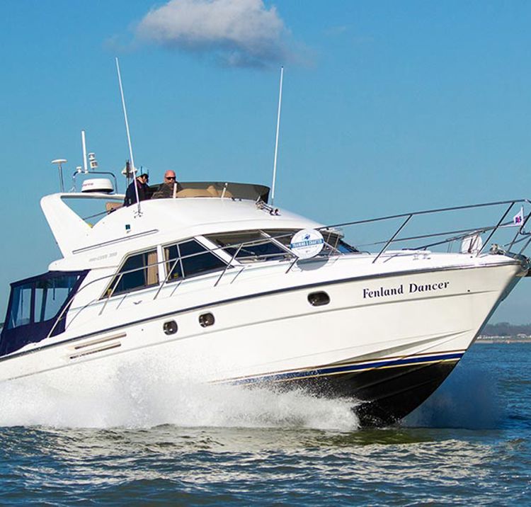 motor cruiser Fenland Dancer on the ocean with crashing waves