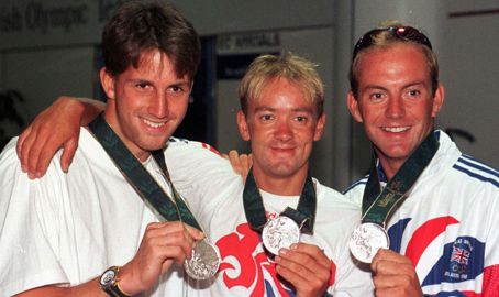 Olympic sailors posing with their silver medals 
