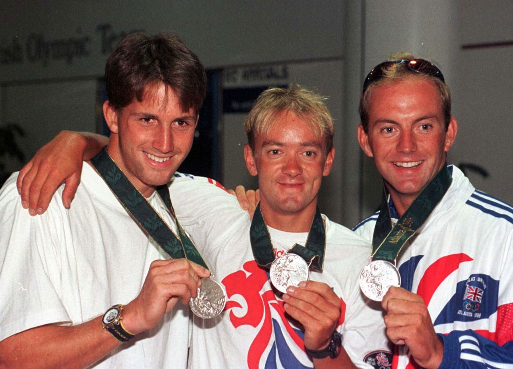 Olympic sailors posing with their silver medals 
