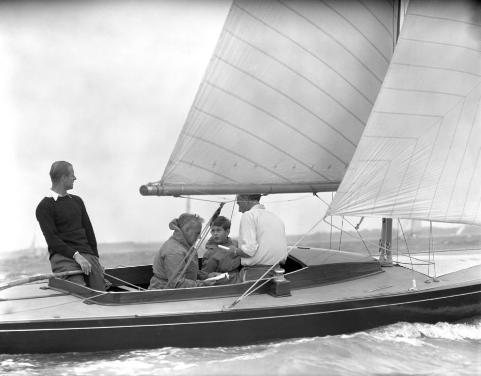 Black and white photo of Prince Philip and son on a boat