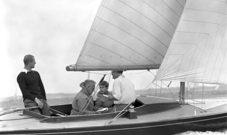Black and white photo of Prince Philip and son on a boat