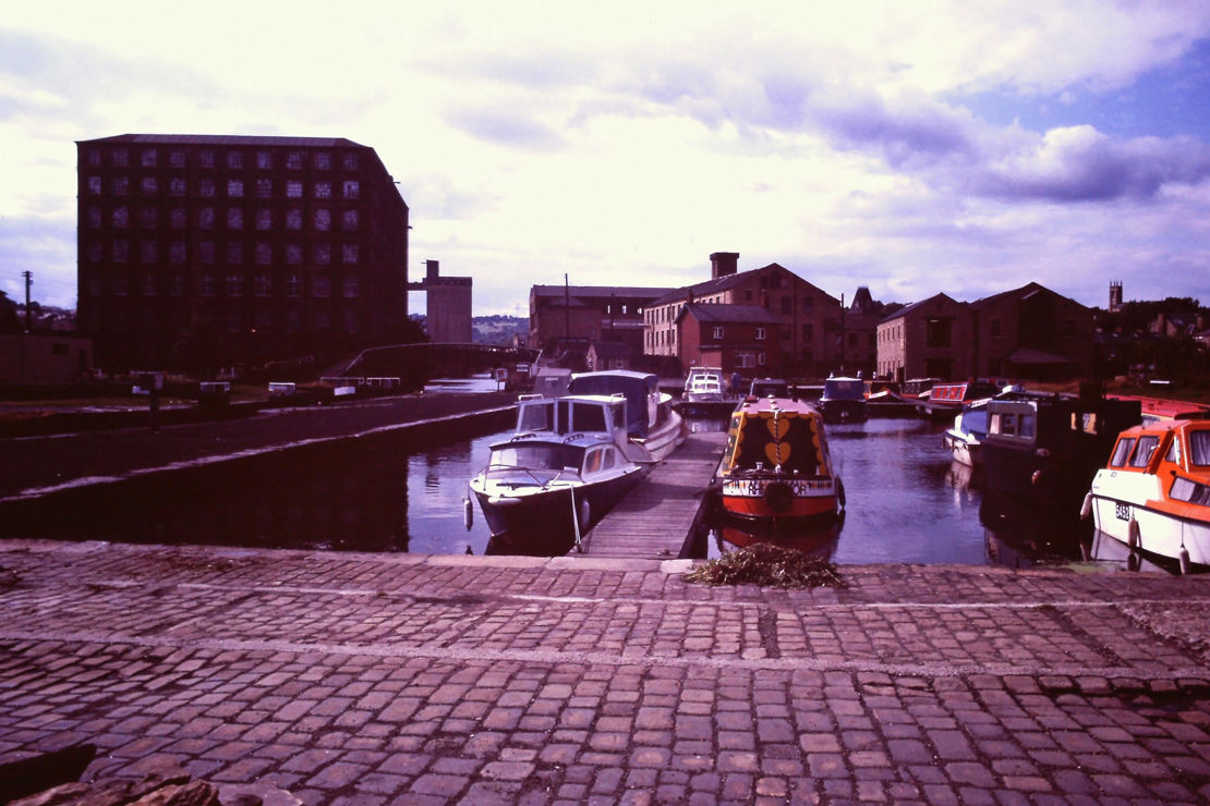 Sepia image of canal boats docked on a lake