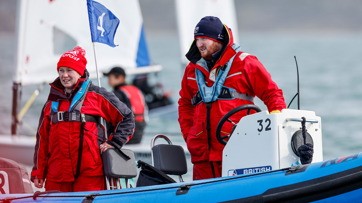 Two sailors on a Rib looking out at the water