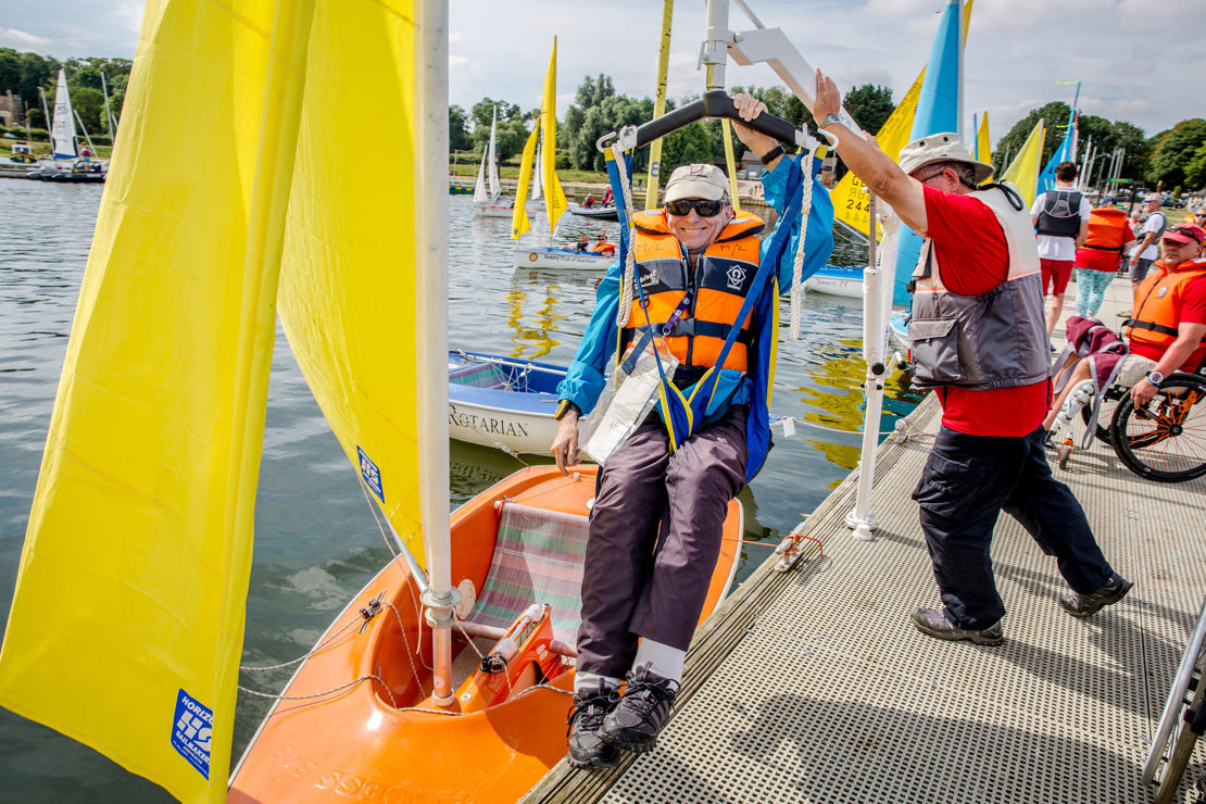 Sailability sailor being lowered into boat