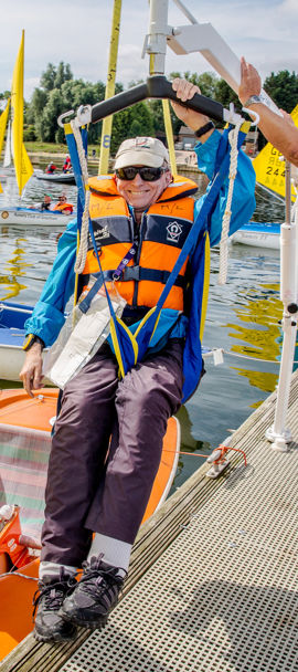 Sailability sailor being lowered into boat