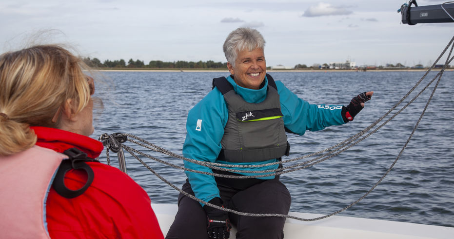closeup of two women sailing a dinghy