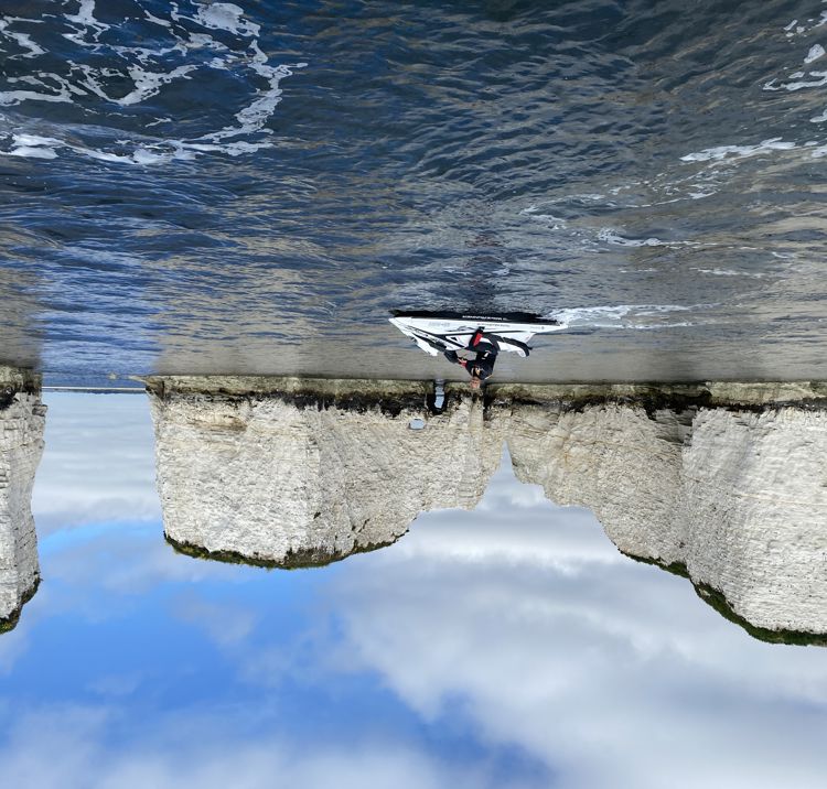 mid shot of personal water craft (jet ski) with white cliffs in the background
