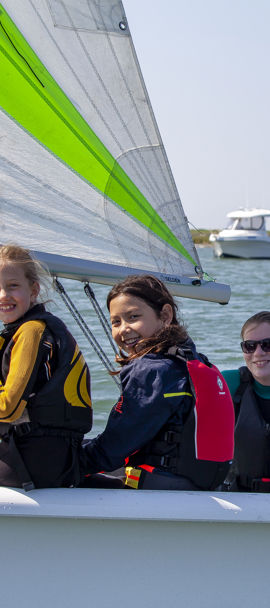 	a group of children in an RS quest sailing dinghy