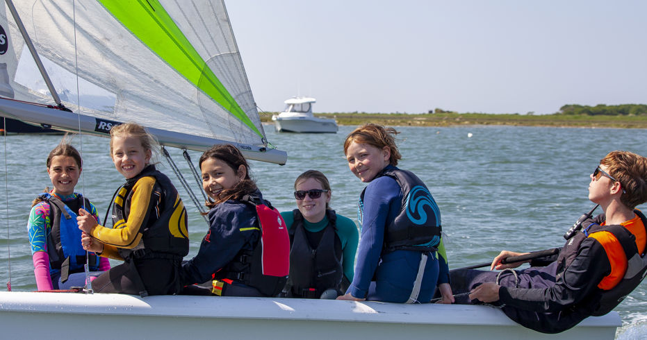 	a group of children in an RS quest sailing dinghy