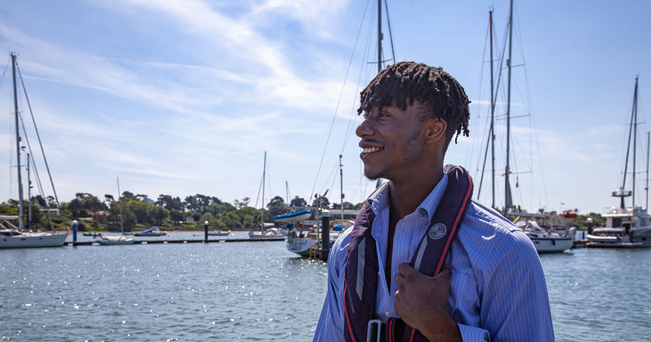 close up of man wearing a buoyancy aid and smiling