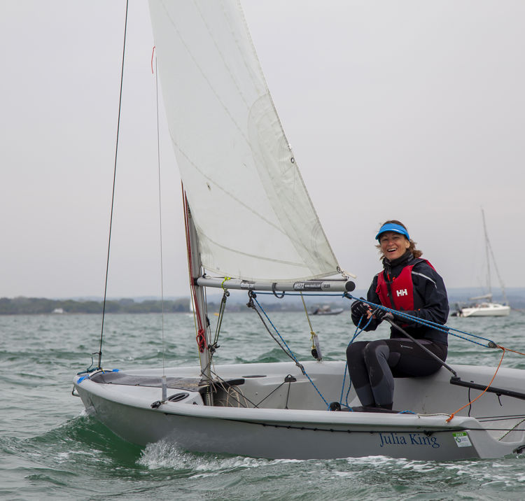 Woman steering RS feva sailing dinghy