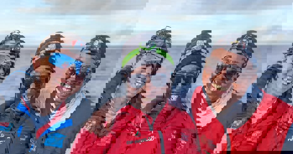 Smiling women with two children who are also smiling