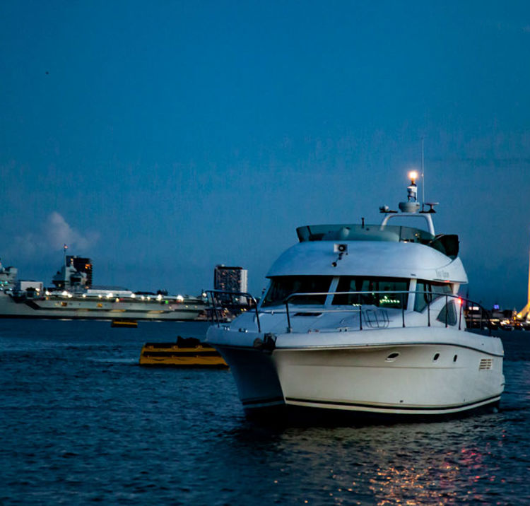Powerboat sailing at night with navigation lights