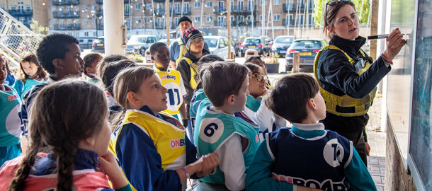Mid shot of group of children being taught using a whiteboard
