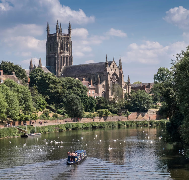 Boat sailing through lake with church in the background