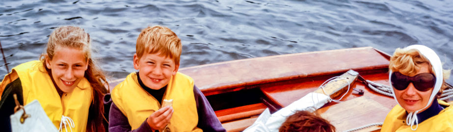 Children laughing and smiling on a small dinghy 