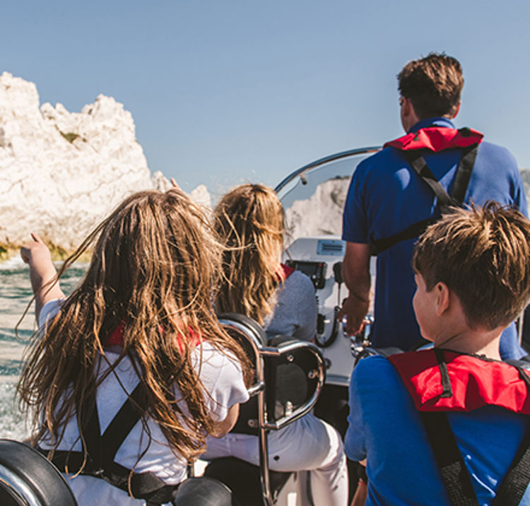 Young sailors on a powerboat with instructor