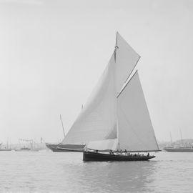 Black and white image of traditional sail boat with large sails