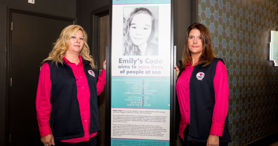 Emily's family stood next a poster promoting Emily's code