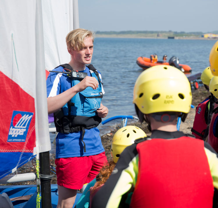 Children listening to instructions from volunteer