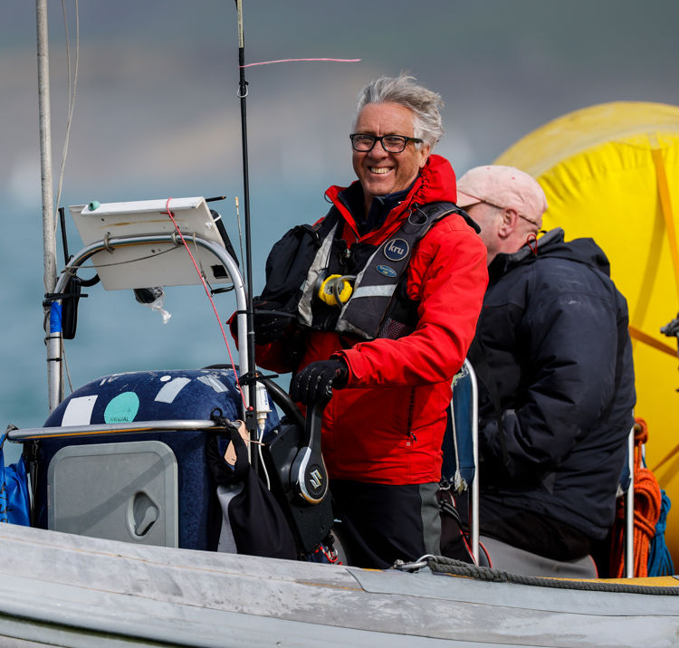 Volunteers laughing and smiling on a RIB