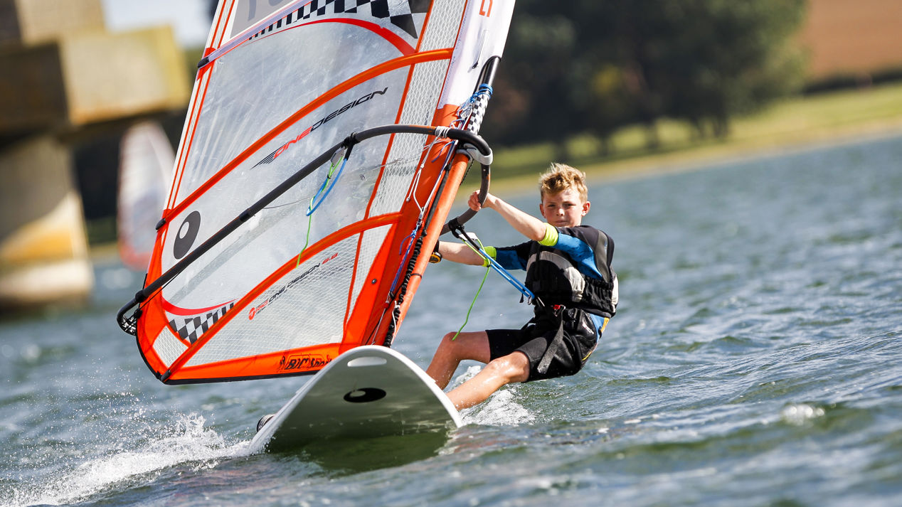 Young Boy on Windsurfing Board at Oscar Shaw National Windsurfing Champs Rutland