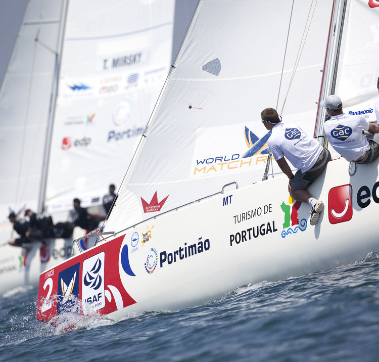 sailors sat on the edge of their boat