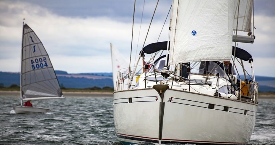 mid shot of yacht sailing with trainees 
