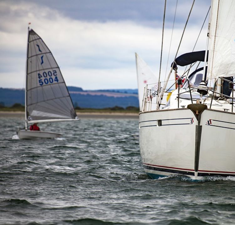 mid shot of yacht sailing with trainees 