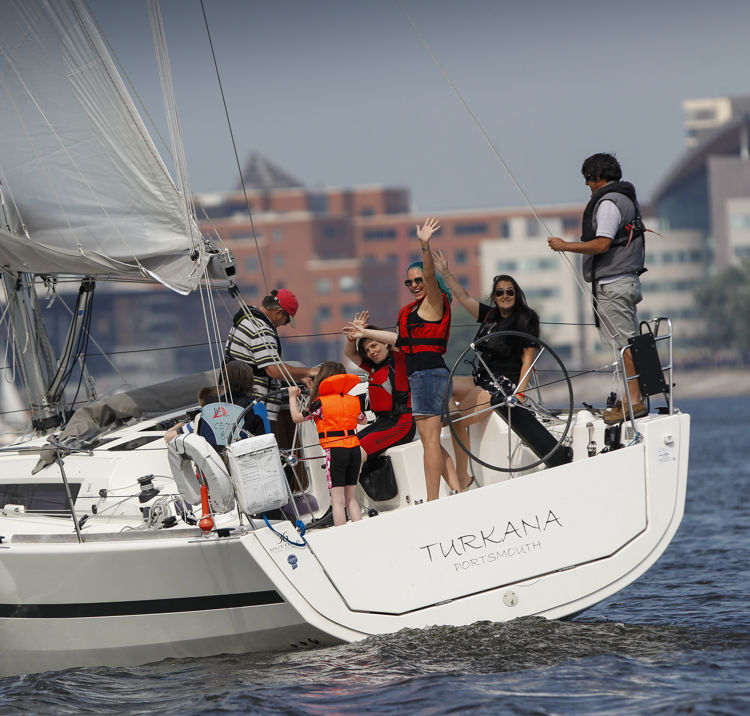 Yacht With Women Waving City Backdrop