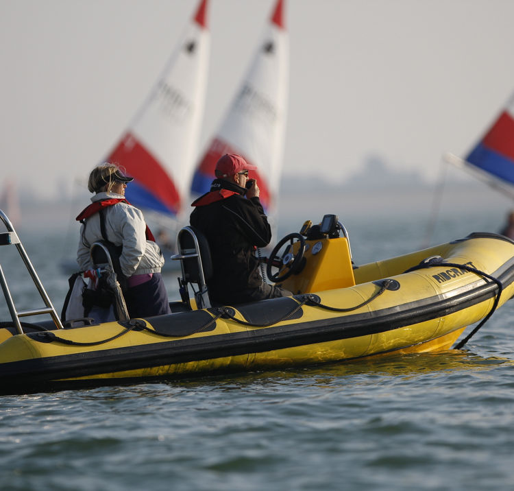 Yellow boat with race officials onboard 